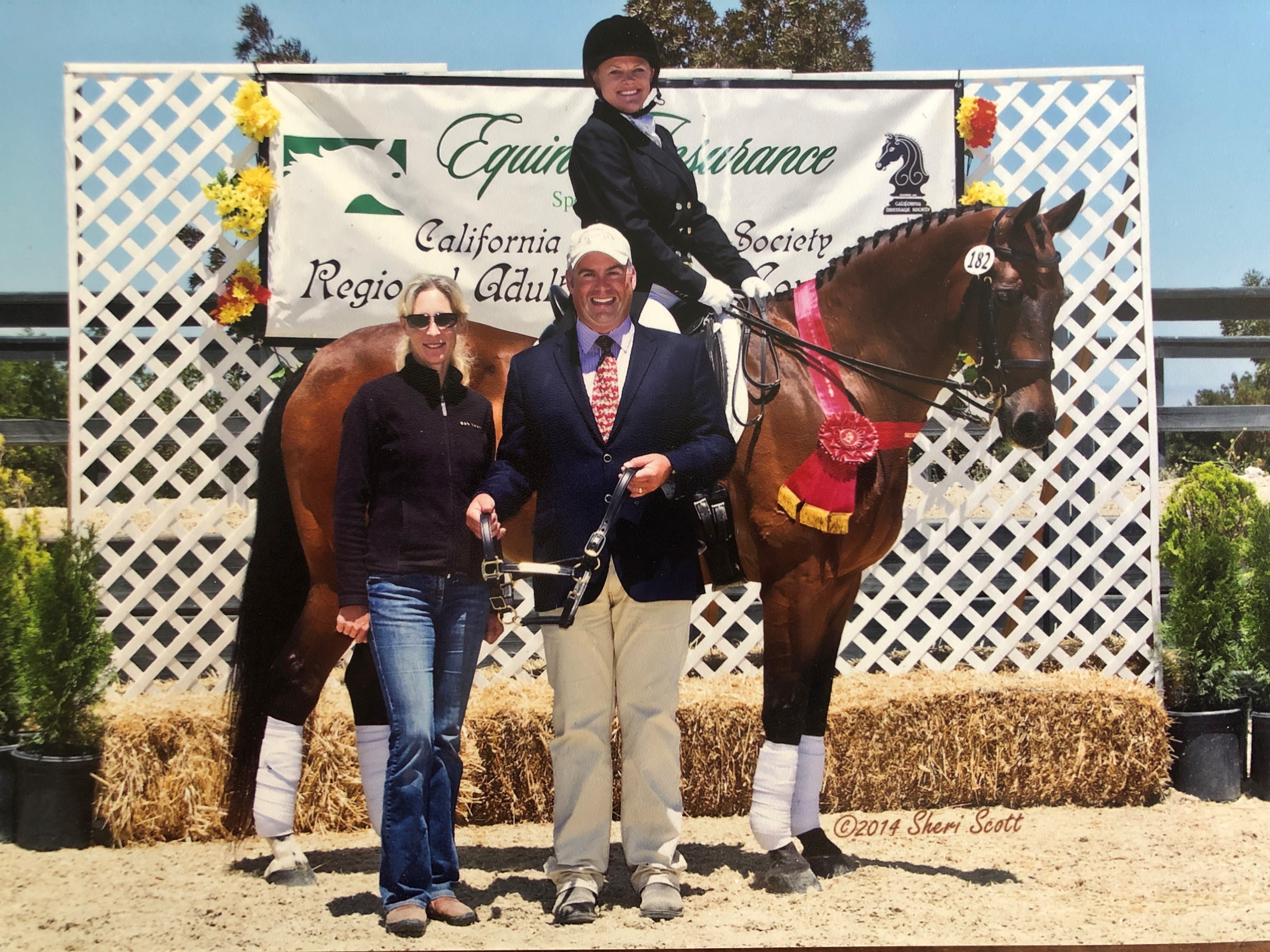 Pam Englund and her horse Laser receiving a championship award